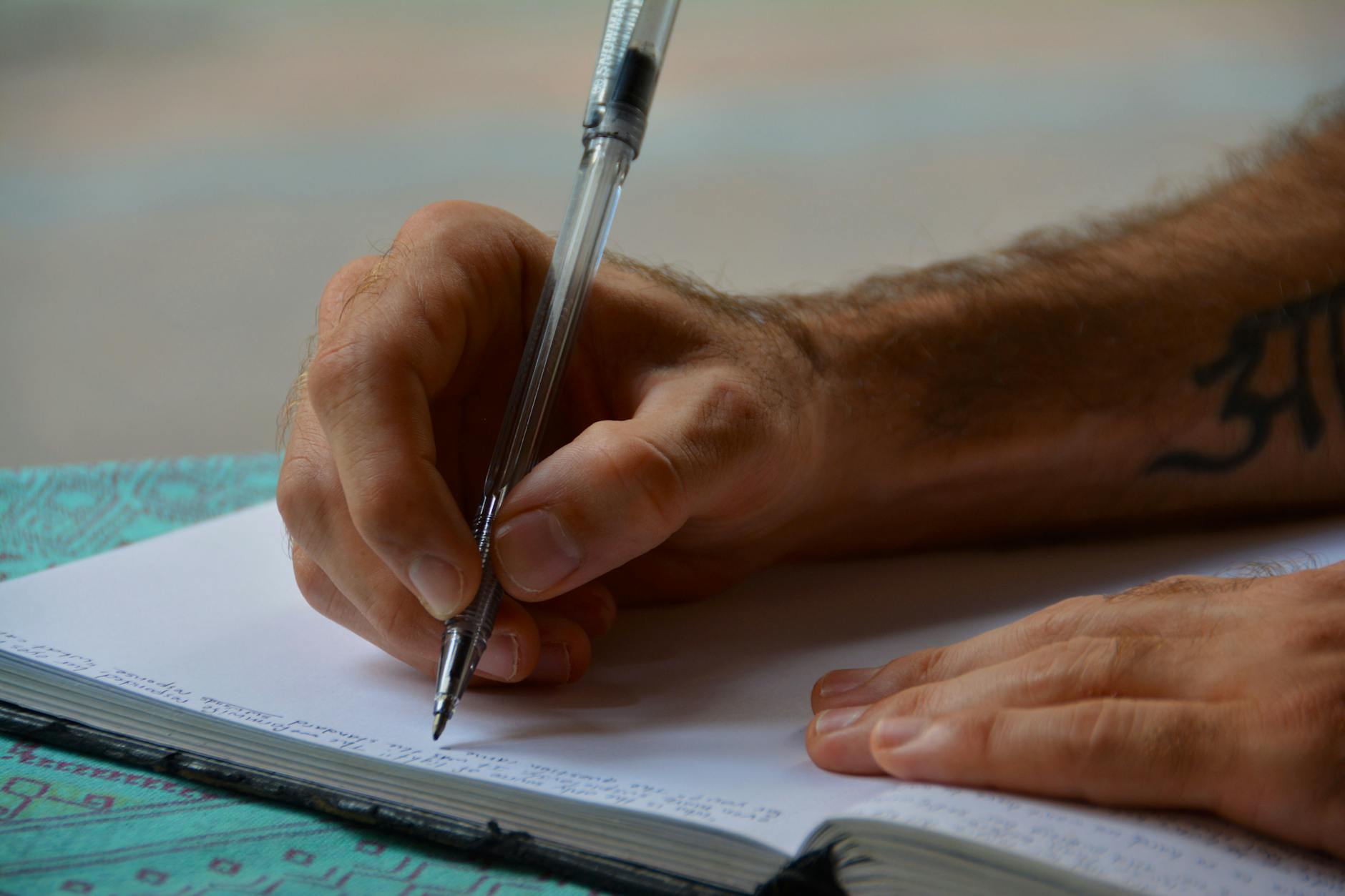 Close-up of a person writing in a notebook, focusing on hands and pen, ideal for study or busines... (Photo by Pixabay on Pexels)